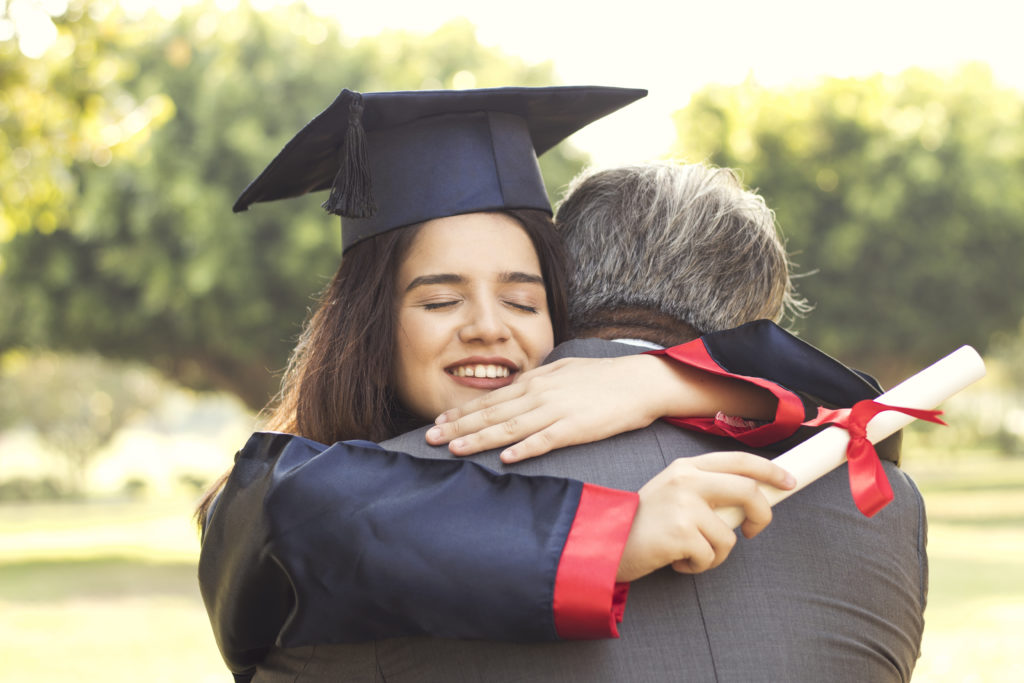 graduate girl hugging dad