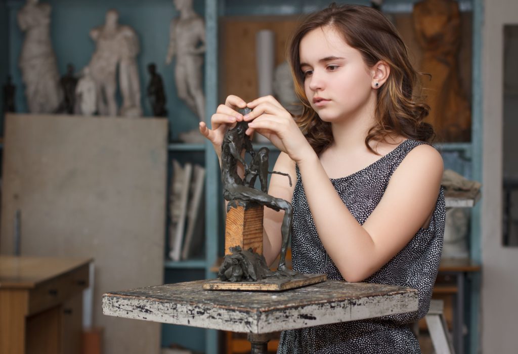 girl working on sculpture