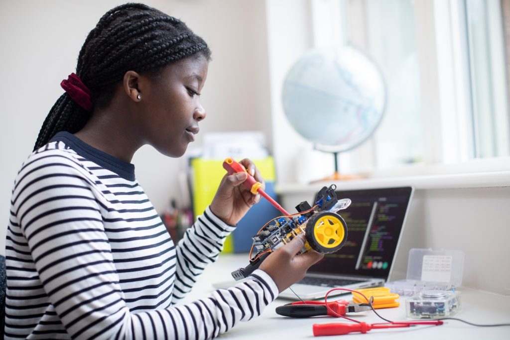 young woman of color working on robotics project
