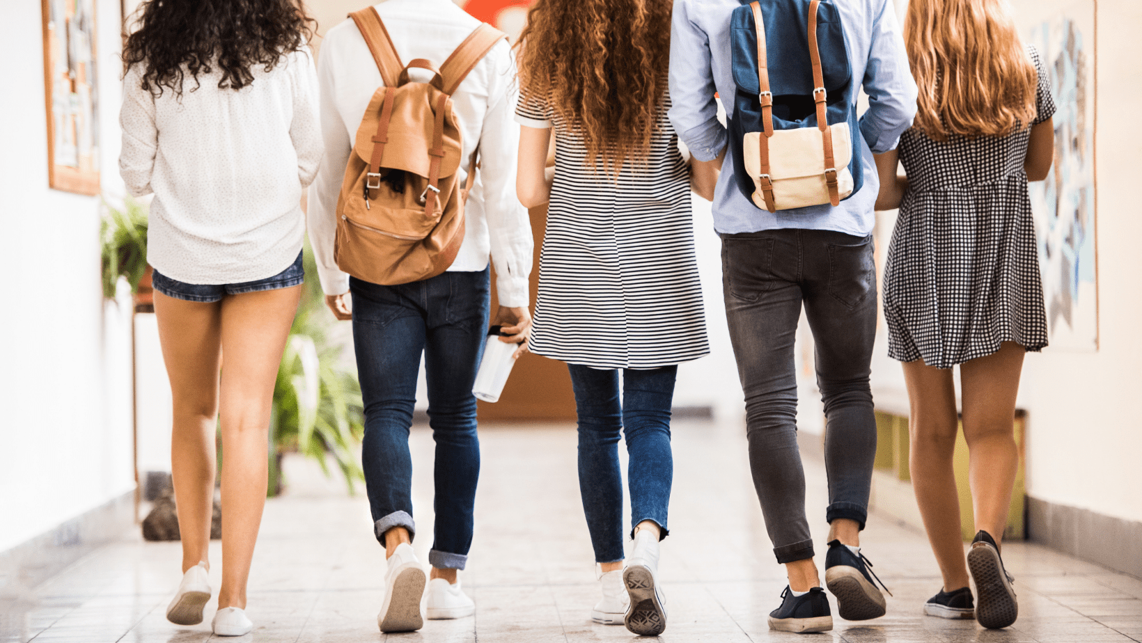 five teen girl students walking, viewed from behind