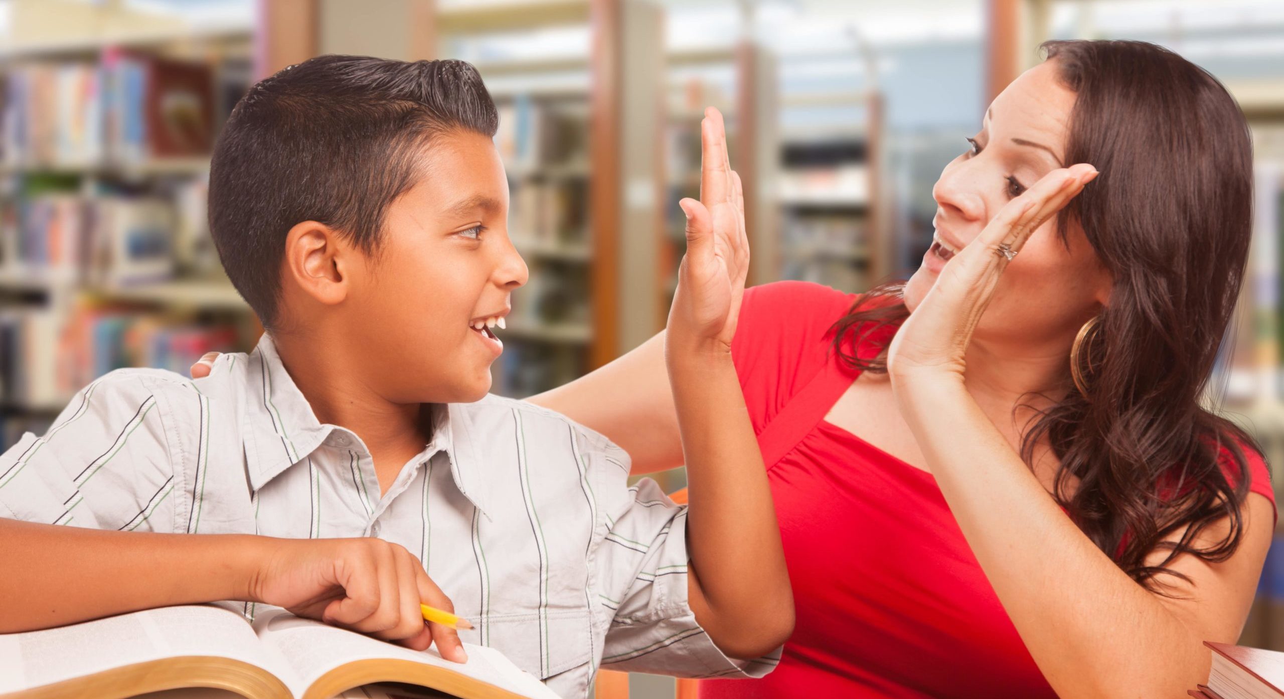student getting high five from tutor